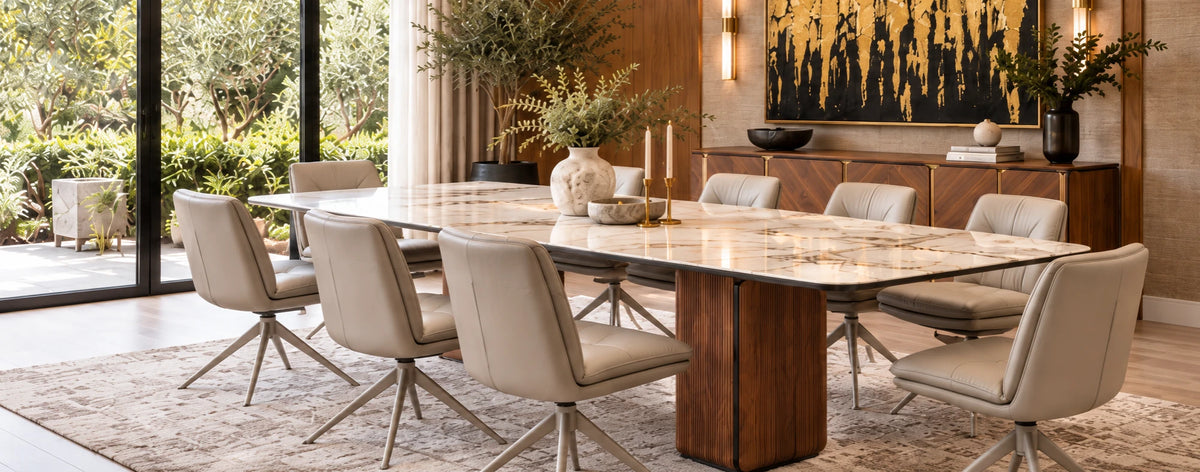 Marble-top dining table on a fluted walnut pedestal with cream leather swivel dining chairs